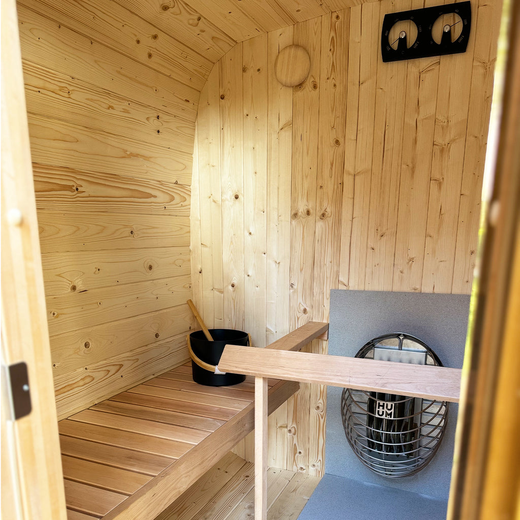 KeiCo ICON 200 Cube Spruce Sauna interior with Aspen Benches and featuring Inclusive KC Wellness Pack 