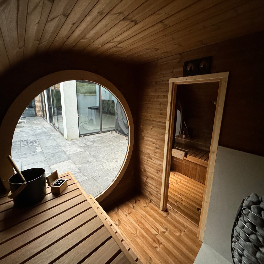 Interior View of The KeiCo Raiki Outdoor Sauna with Cozy Seating and Heater