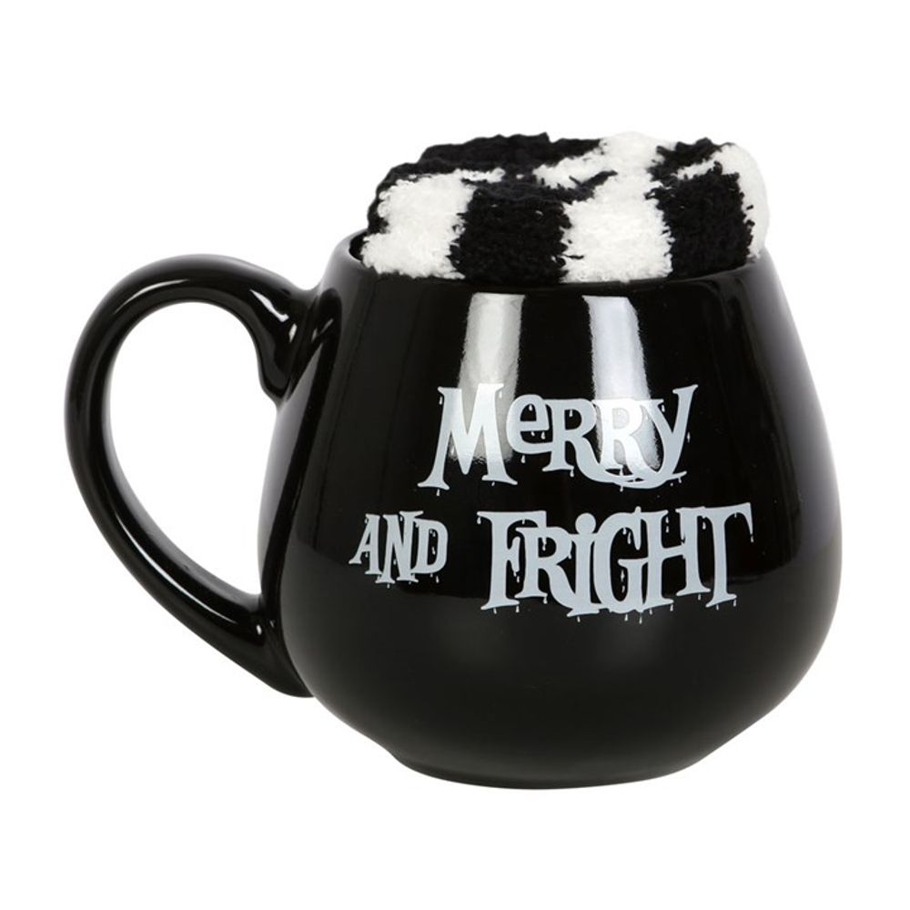 KeiCo's Merry and Fright black mug next to the contrasting black and white striped socks, setting the mood for a mystical winter evening.